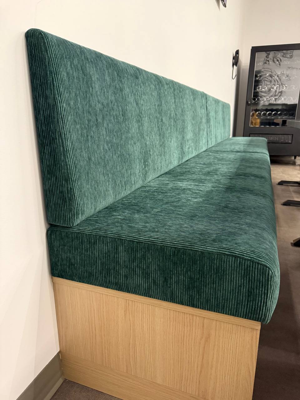 Cognac leather restaurant banquette corner detail — commercial upholstery Montreal