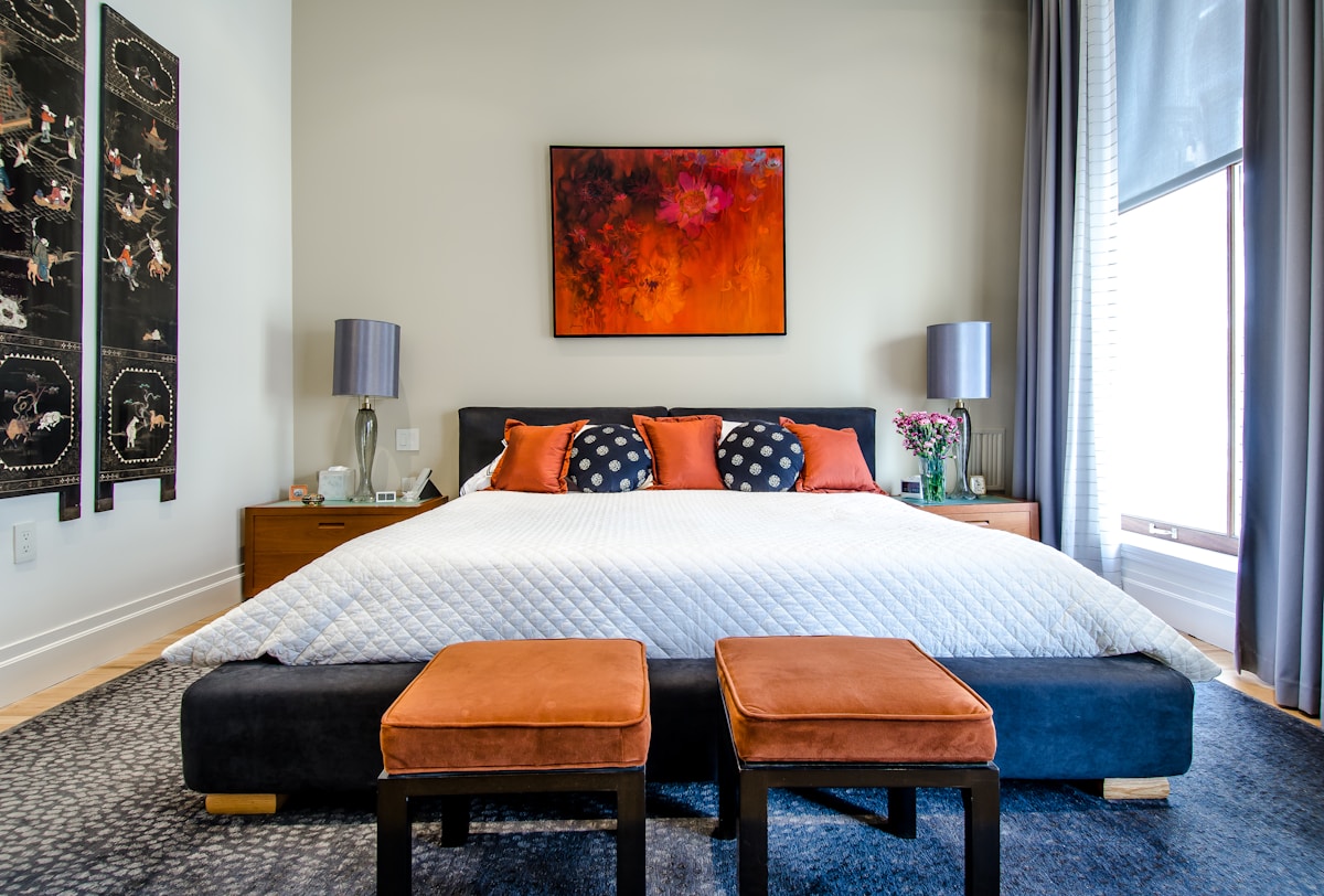 Custom grey velvet wall panels and integrated headboard — bespoke bedroom upholstery Montreal by Atlas