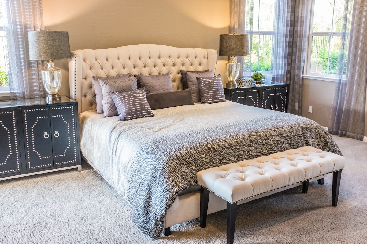 Custom cream upholstered bed frame with tall panelled headboard — Atlas Upholstering Montreal